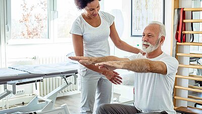 Physiotherapeutin und Krebspatient im Reha Sport. 